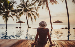 Tourist im Luxus-Strandhotel in der Nähe des luxuriösen Pools bei Sonnenuntergang,tropische exotische Ferien Urlaub,Tourismus und Reisen
