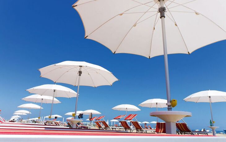 white beach umbrellas on Rimini beach, Italy